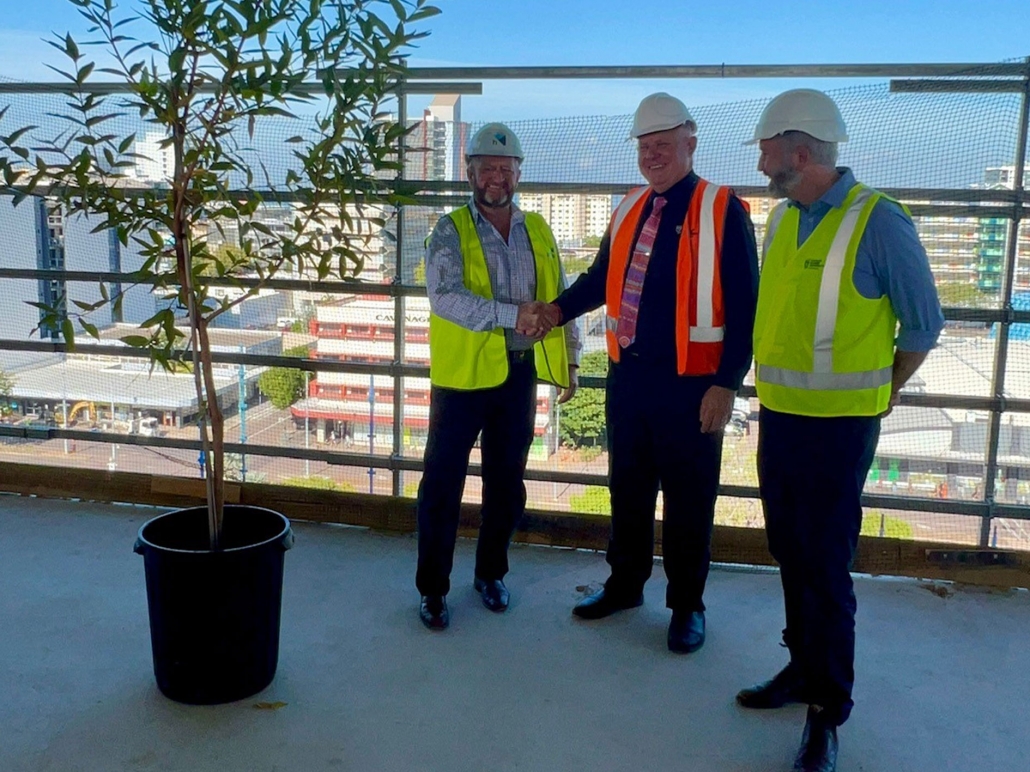 From L to R: Halikos Managing Director Shane Dignan, CDU Vice-Chancellor Professor Scott Bowman and Assistant Minister for Regional Development and Education, Senator Anthony Chisholm with the gift of a tree to honour the completion of the super structure.